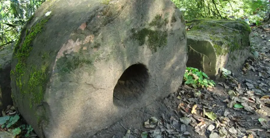A small grindstone, found nearby in the river, is set into the bank next to the main overflow of the Swallow mill dam. Photo: Sue Shaw, September 2011